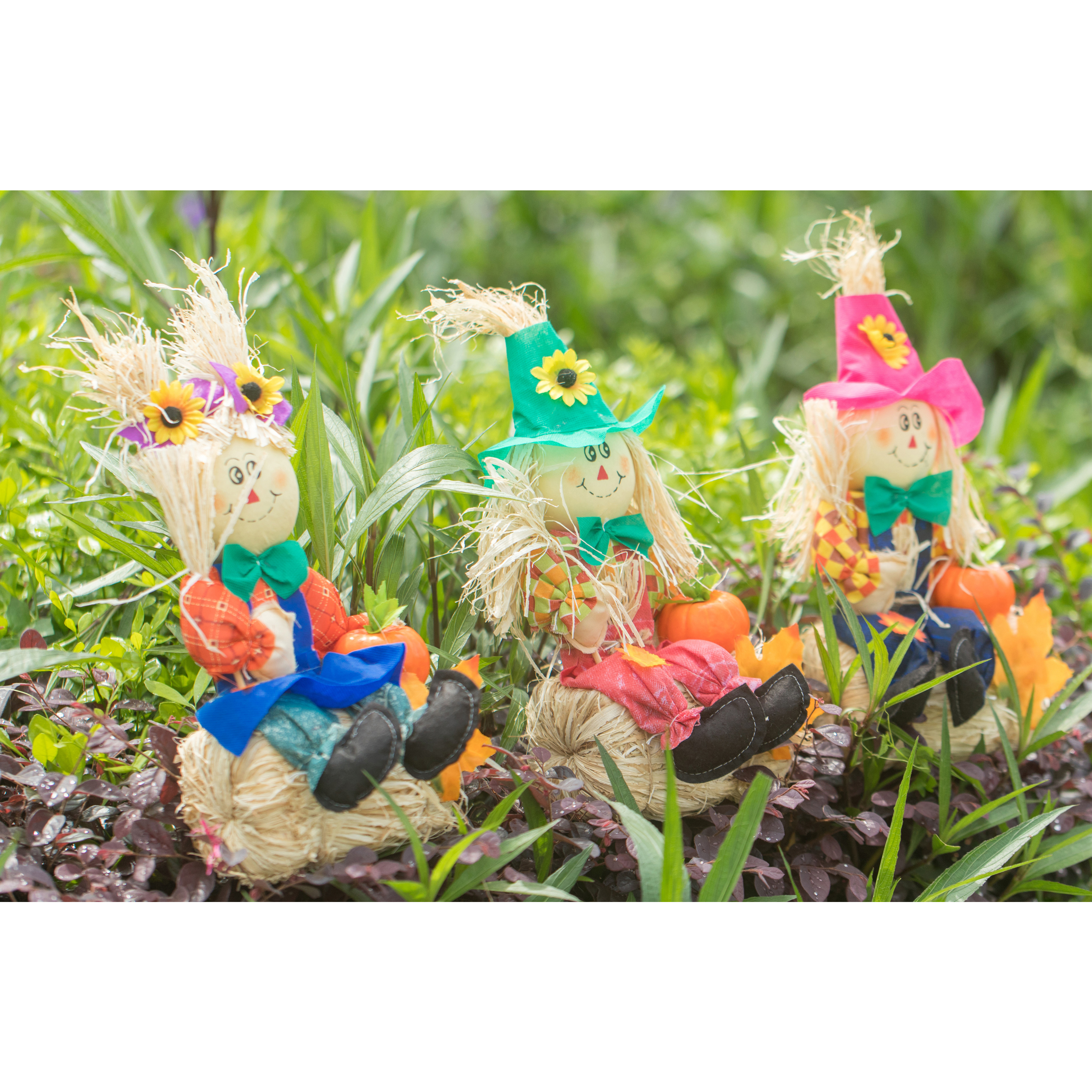 Set Of 3 Garden Scarecrows Sitting On Hay Bale